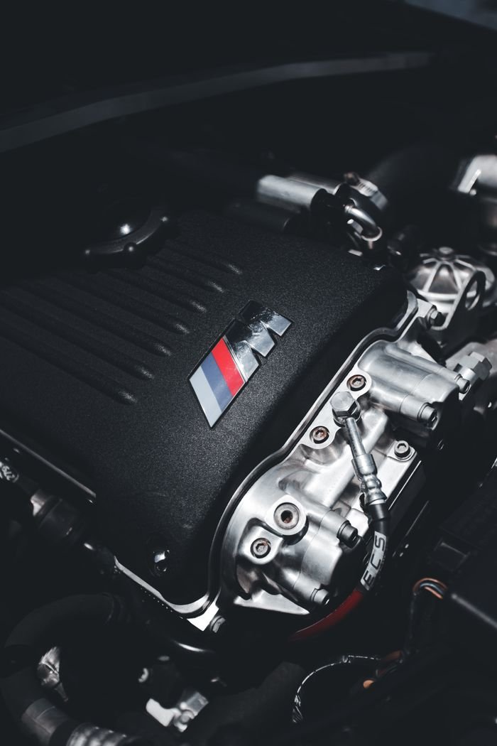 Detailed view of a high-performance engine in a car, showcasing power and engineering precision.