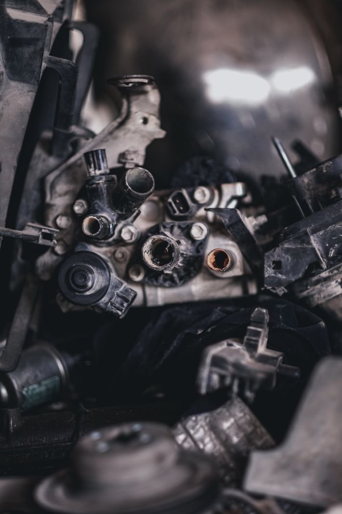 Detailed view of various disassembled engine components in an auto repair shop.
